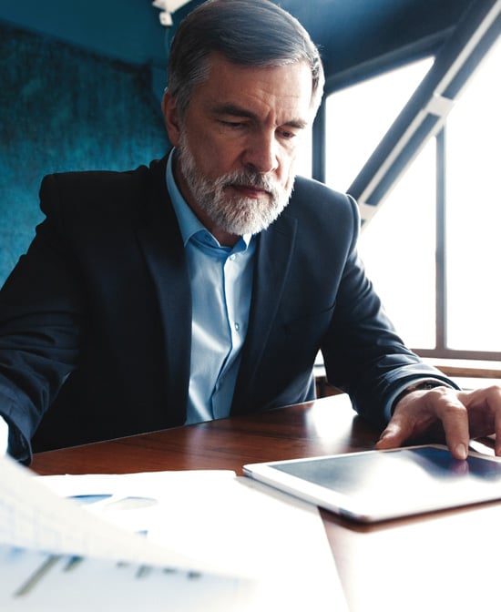 A business owner reviewing the findings provided by One Step's Cybersecurity Risk Assessment.