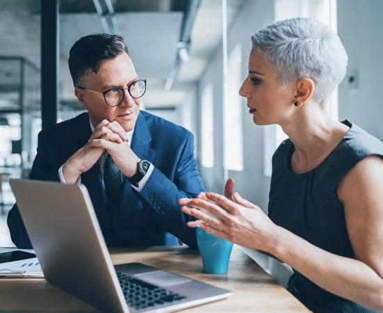 IT specialist explaining to business owner the importance of cybersecurity.