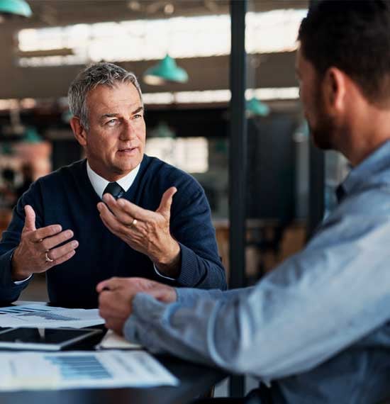 IT consultant providing expert guidance to a business owner on improving IT infrastructure and cybersecurity