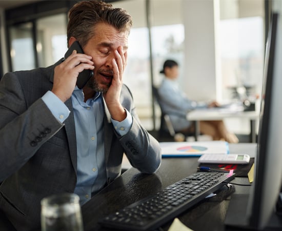 Image of a man showing frustration in front on his computer symbolizing the frustration faced when dealing with outdated technology.