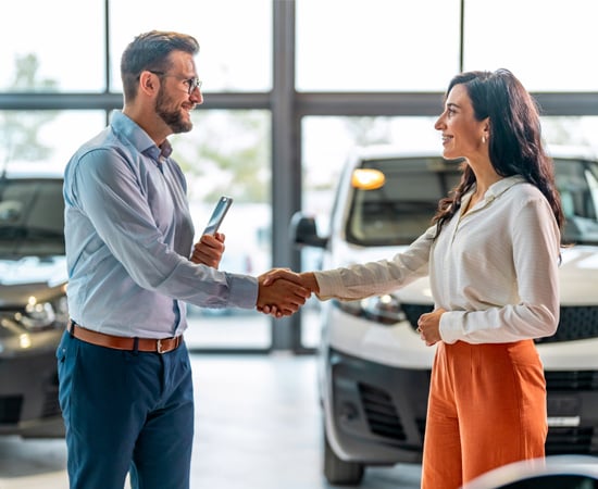 An image with a female and man shaking hands symbolizing the car dealer owner trusting One Step Secure IT expert with their sensitive assets.