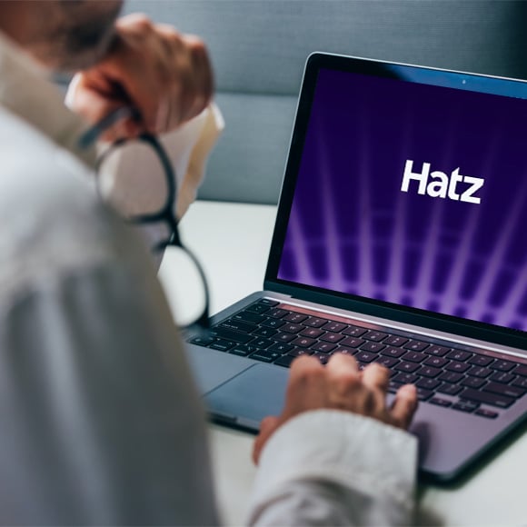 Employee viewing the Hatz AI logo on a laptop.