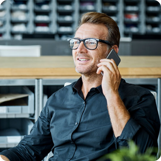 Business man taking the next by calling One Step Secure IT on the phone.